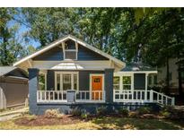 Charming renovated home with a freshly painted exterior, inviting porch, and well-manicured front yard at 943 Rose Sw Cir, Atlanta, GA 30310