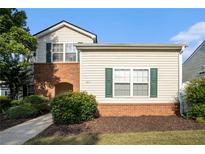 Charming two-story home with classic siding and a welcoming brick facade, showcasing curb appeal at 139 W Oaks Pl, Woodstock, GA 30188