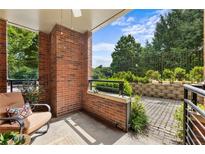 Charming patio area with brick accents, manicured landscaping, and a comfortable seating arrangement at 273 12Th Ne St # 111, Atlanta, GA 30309