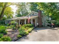 Charming single-Gathering home featuring a brick chimney, landscaped front yard, and ample parking on a sunny day at 4442 Academy St, Acworth, GA 30101