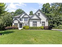 Charming two-story home showcasing a manicured lawn and well-maintained landscaping at 135 Emerald Ln, Roswell, GA 30075