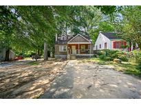 Charming bungalow with a front porch and mature trees at 1876 Madrona Street Nw St, Atlanta, GA 30318