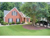 Charming brick home with well-manicured lawn and mature trees offering curb appeal at 3030 Larkspur Ct, Cumming, GA 30041