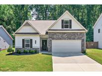 Charming single-Gathering home features a stone facade, attached two-car garage, and a well-manicured front lawn at 165 Winner St, Acworth, GA 30102