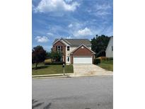 Charming two-story home featuring a well-maintained front yard and attached garage at 2147 Saint Albans Pl, Buford, GA 30519