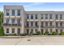 Charming townhomes with awnings and beautiful landscaping offer inviting curb appeal at 304 Stonemont Dr, Atlanta, GA 30305