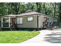 Charming home featuring a landscaped front yard, covered porch, and a freshly painted exterior at 3200 Lowndes St, East Point, GA 30344