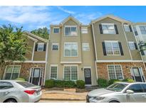 Charming townhome featuring a well-manicured front yard and classic architectural details at 234 Riverstone Commons Cir, Canton, GA 30114