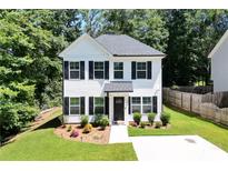 Charming two-story home features a landscaped front yard and classic black and white accents at 5350 Mercedes Dr, Cumming, GA 30041