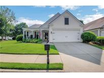 Charming single-story home with manicured lawn and attached two-car garage on a sunny day at 4140 Prince Charles Dr, Duluth, GA 30097