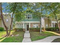 Charming two-story home with green siding and stone accents at , Conyers, GA 30012