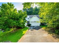 Charming home with a well-manicured lawn and an attached garage, framed by lush green trees, offering great curb appeal at 3793 Market Cres, Clarkston, GA 30021