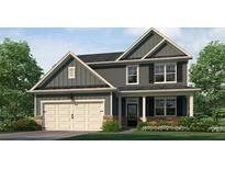 Charming two-story home with a two-car garage, covered entry, and beautifully landscaped front yard at 915 Sundown Pt, Villa Rica, GA 30180