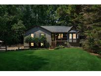 Charming home featuring a lush green lawn and inviting screened in front porch perfect for relaxing outdoors at 202 Cedar Valley Ct, Canton, GA 30115
