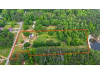 Expansive aerial view of a verdant, wooded property with lake access and an orange border line at 901 N Van Wert N Rd, Villa Rica, GA 30180