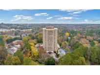 High-rise condo building with a circular driveway and lush trees surrounding the premises at 1501 Clairmont Rd # 1731, Decatur, GA 30033