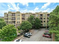 View of apartment building with parking area and landscaping at 425 Chapel Sw St # 1211, Atlanta, GA 30313