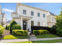 Charming two-story home featuring a covered entrance, complemented by manicured shrubs and a well-maintained lawn at 6820 Colfax Ave, Cumming, GA 30040