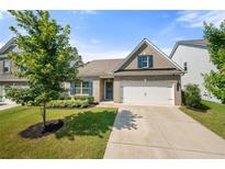 Charming brick home featuring a two-car garage, manicured lawn, and beautiful landscaping at 5318 Burrus Ln, Mableton, GA 30126