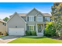 Charming two-story home featuring a well-manicured lawn, a two-car garage and beautiful front yard landscaping at 290 Prescott Dr, Acworth, GA 30101