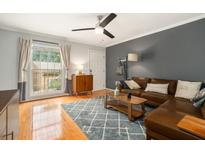 Inviting living room featuring a comfortable leather sofa, stylish rug, and abundant natural light at 1101 Collier Nw Rd # K5, Atlanta, GA 30318