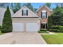 Charming home with a two-car garage, well-manicured lawn, and mature trees at 3686 Claredun Ct, Cumming, GA 30040