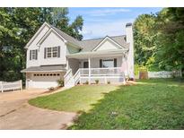Charming home with an attached garage, inviting front porch, and well-manicured lawn at 4292 Hurt Bridge Rd, Cumming, GA 30028