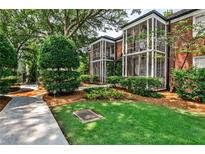 Brick exterior with screened porches overlooking landscaped lawn and walkway at 55 Delmont Ne Dr # C3, Atlanta, GA 30305