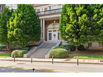 Classic brick building with a grand entrance and mature landscaping at 30 5Th Ne St # 1010, Atlanta, GA 30308