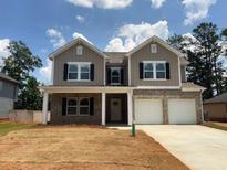 Charming two-story home with a welcoming front porch and a two-car garage at 3536 Dogwood Pass, Lithonia, GA 30038
