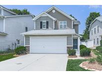 Charming two-story home with a two-car garage, stone accents, and a well-maintained front lawn at 232 Oconee Way, Canton, GA 30114