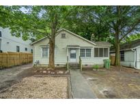 Charming single-story home with a covered porch and mature trees providing shade at 724 Bellemeade Nw Ave, Atlanta, GA 30318