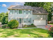 Charming two-story home with a well-manicured lawn and a two-car garage, perfect for Gathering living at 740 Paris Dr, Lawrenceville, GA 30043