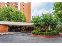 Wide driveway leading to the main entrance of a brick apartment building surrounded by green landscaping at 300 Johnson Ferry Ne Rd # B808, Atlanta, GA 30328