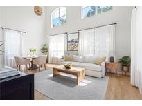 Bright living room with large windows, light wood floors, and white sofa at 300 Brickworks Ne Cir # 302, Atlanta, GA 30307