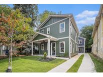 Charming green two-story home with a covered front porch and well-manicured lawn at 50 Howell Se St # A, Atlanta, GA 30312