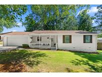 Charming single-story home with a covered porch and well-maintained lawn at 830 The Cir, Lawrenceville, GA 30043
