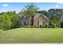 Beautiful two-story brick home with a well-manicured lawn and mature landscaping at 2660 Brentwood Estates Ct, Cumming, GA 30041
