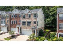 Beautiful brick and vinyl townhome with a two-car garage and manicured landscaping at 3733 Chattahoochee Summit Se Dr # 7, Atlanta, GA 30339