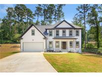 Charming two-story home boasts a manicured lawn and inviting front porch at 3439 Twin Village Ct, Snellville, GA 30039