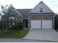 Charming single-Gathering home with stone accents, well-maintained lawn and two-car garage at 5252 Inverness Ct, Douglasville, GA 30135