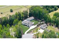 Stunning aerial view of estate home, guest house, horse barn, pool, and well landscaped grounds at 604 Trinity Church Rd, Canton, GA 30115