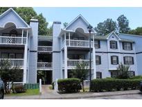 Charming condo building features balconies, classic architecture, and well-maintained landscaping at 3501 Shepherds Path, Decatur, GA 30034