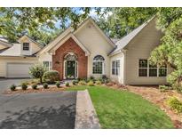 Charming home featuring a brick entryway, manicured lawn, and mature landscaping at 1249 Creek Forest Ln # Bldg 8, Austell, GA 30106