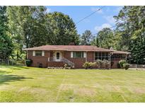 Charming brick ranch home with a well-manicured front lawn and a inviting entryway at 2247 Cypress Ave, Morrow, GA 30260