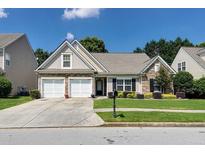 Charming single Gathering home with a well-manicured lawn and a two-car garage at 2423 Walnut Tree Ln, Buford, GA 30519