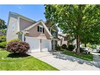 Charming home featuring a two-car garage, well-maintained lawn, and mature trees in a desirable neighborhood at 424 Citronelle Dr, Woodstock, GA 30188