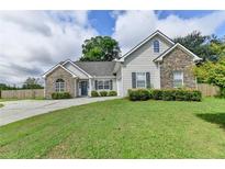 Charming home featuring stone accents, a well-maintained lawn, and a traditional architectural style at 3573 Plantation Pl, Loganville, GA 30052