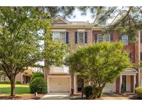 Charming brick townhouse with a one-car garage and mature trees at 5710 Waters Edge Trl, Roswell, GA 30075