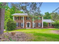 Beautiful two-story brick home with stately columns and a well-manicured front lawn at 965 Grimes Bridge Rd, Roswell, GA 30075